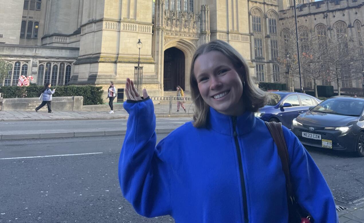 Harper May '24 poses in front of a historic building in Bristol, UK