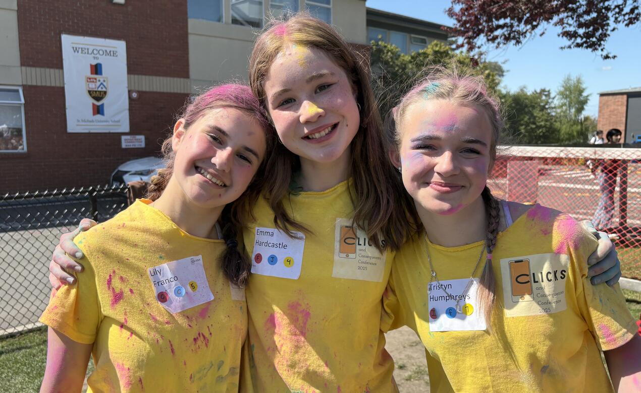 Middle Clicks and Consequences Conference attendees covered in colour powder