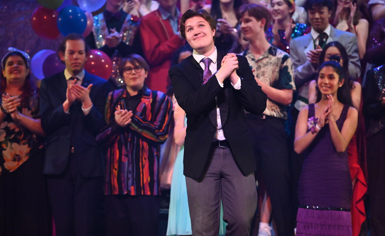 Ben Kuzminski-Parry takes in applause at the Senior School Musical the Prom