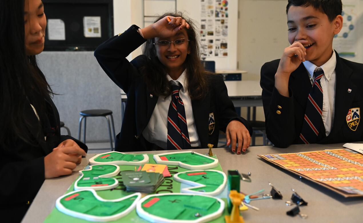 Middle School kids playing a homemade board game