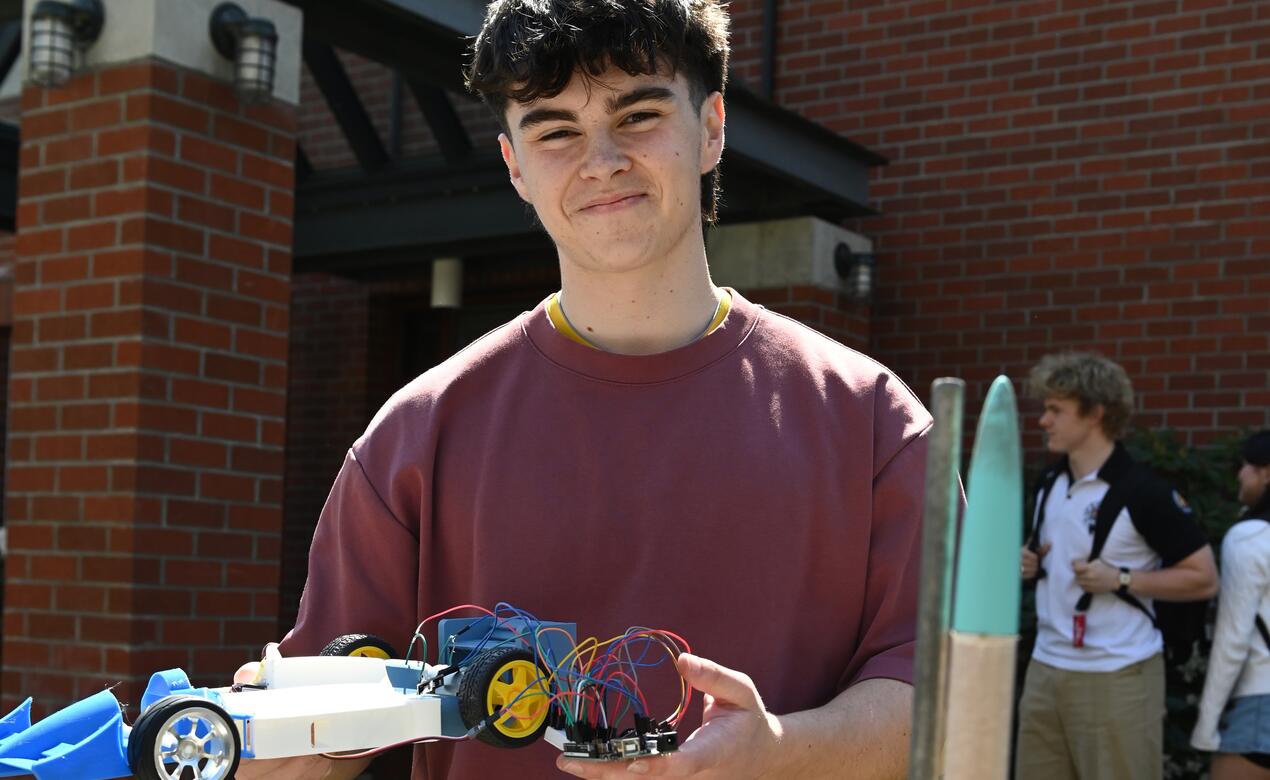 Senior Rhys Tuoy with a car he made