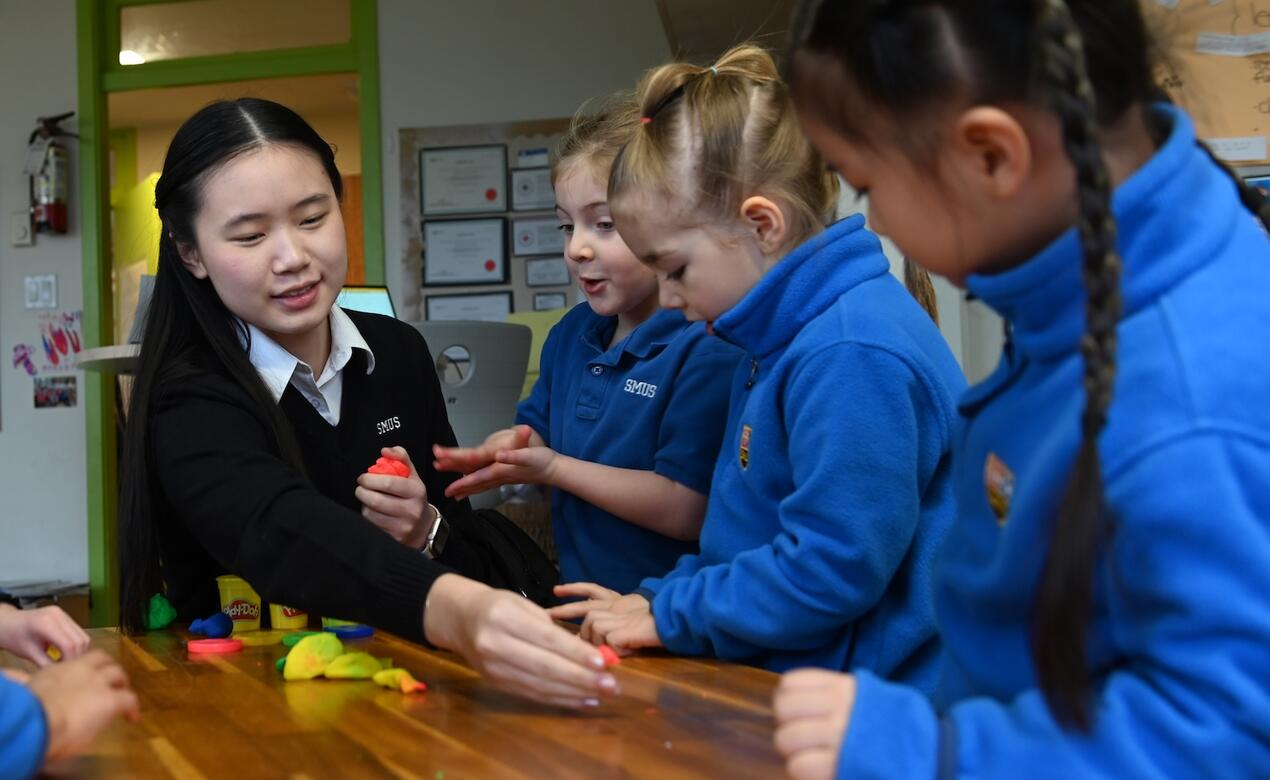 Grade 11 student Cindy Chen plays with JK students