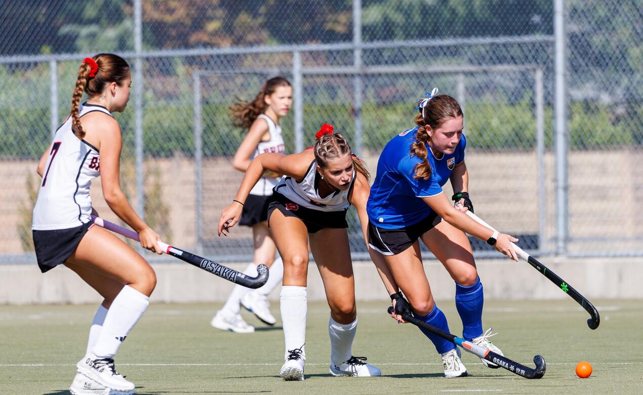 Mackenna Brown dribbles the field hockey ball in competition at the Friendship Cup
