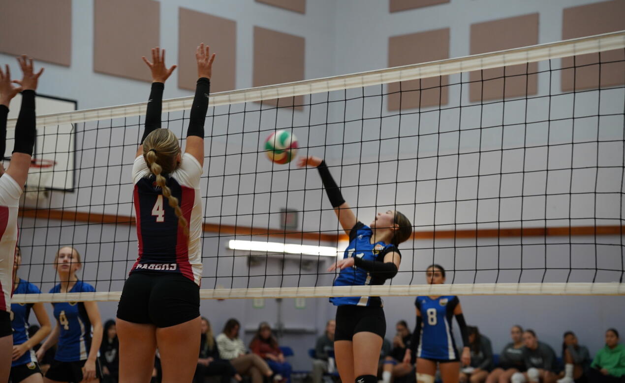 Action at the net with the SMUS Junior Girls Volleyball team