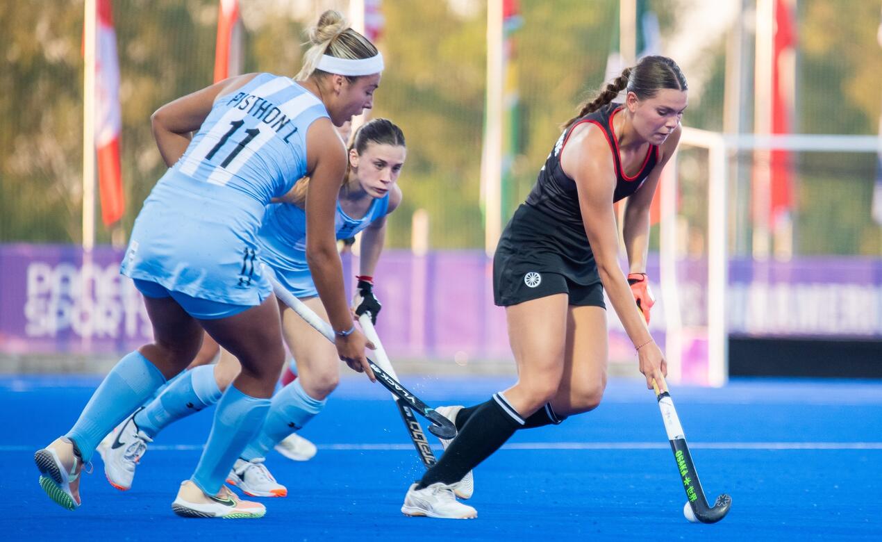 Wynn Brown '23 dribbles the ball in a field hockey game for team Canada