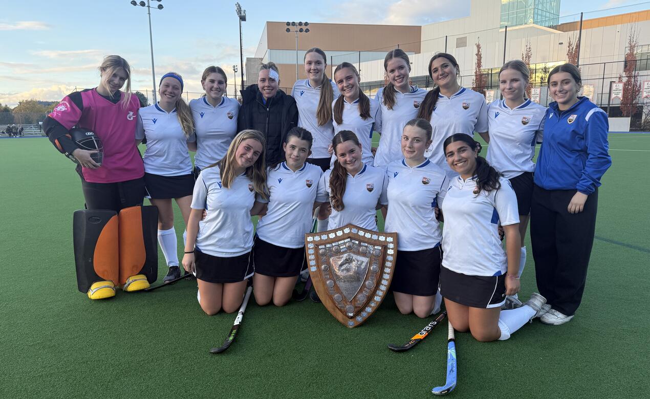 A team photo of the Senior Girls Field Hockey posing with the May Tully shield