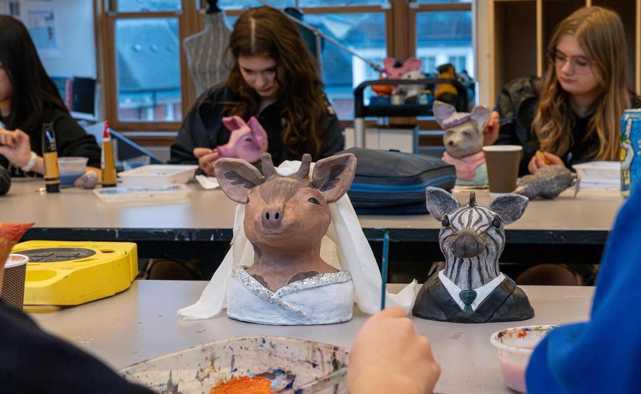 3D Art 9 students with anthropomorphic animal sculptures and paper mache birds.
