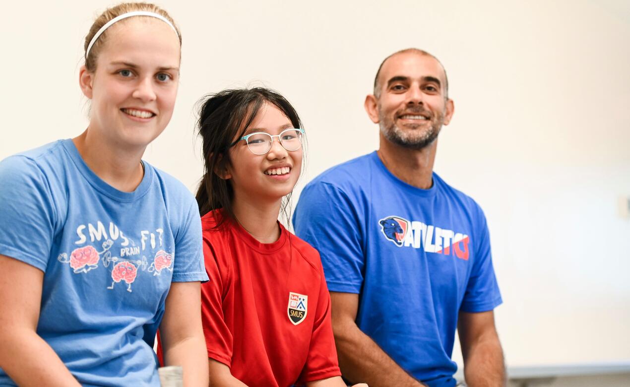 Coach Thomas and Coach Elkeiy with a student
