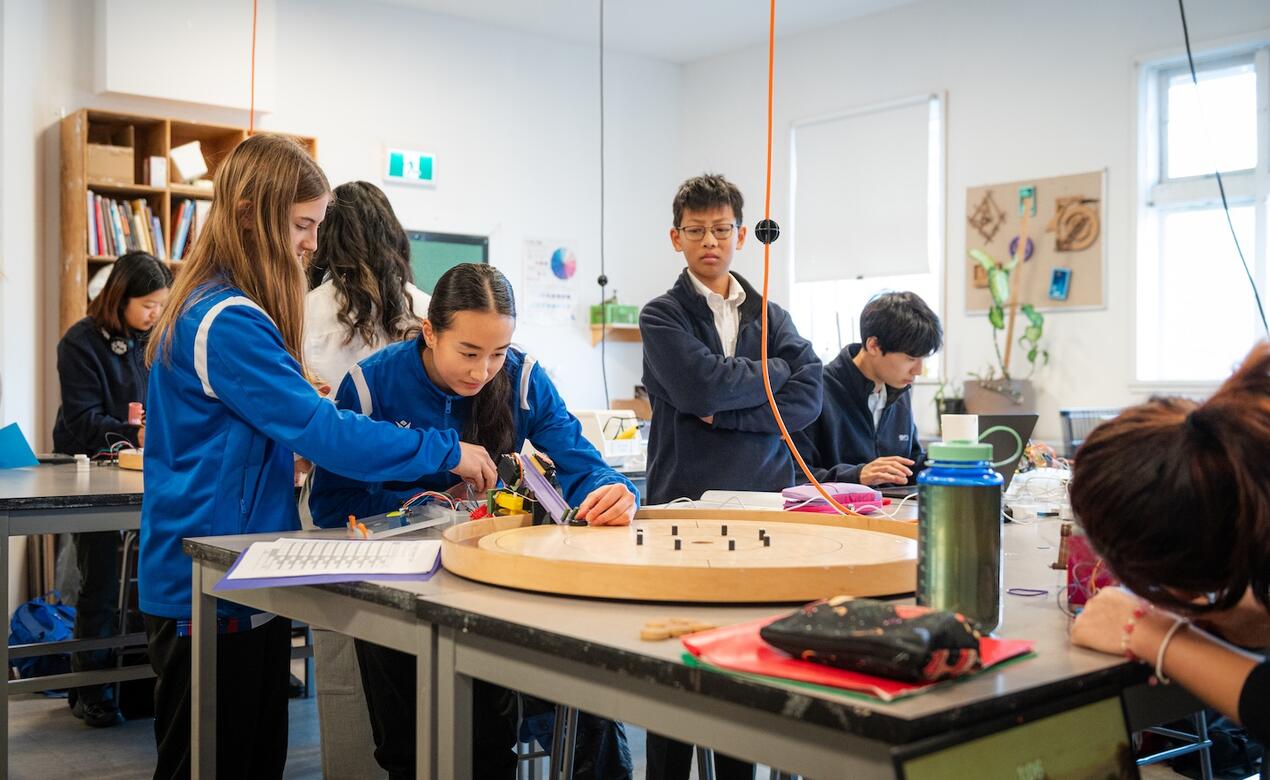 Grade 9 Engineering students test their crokinole machines