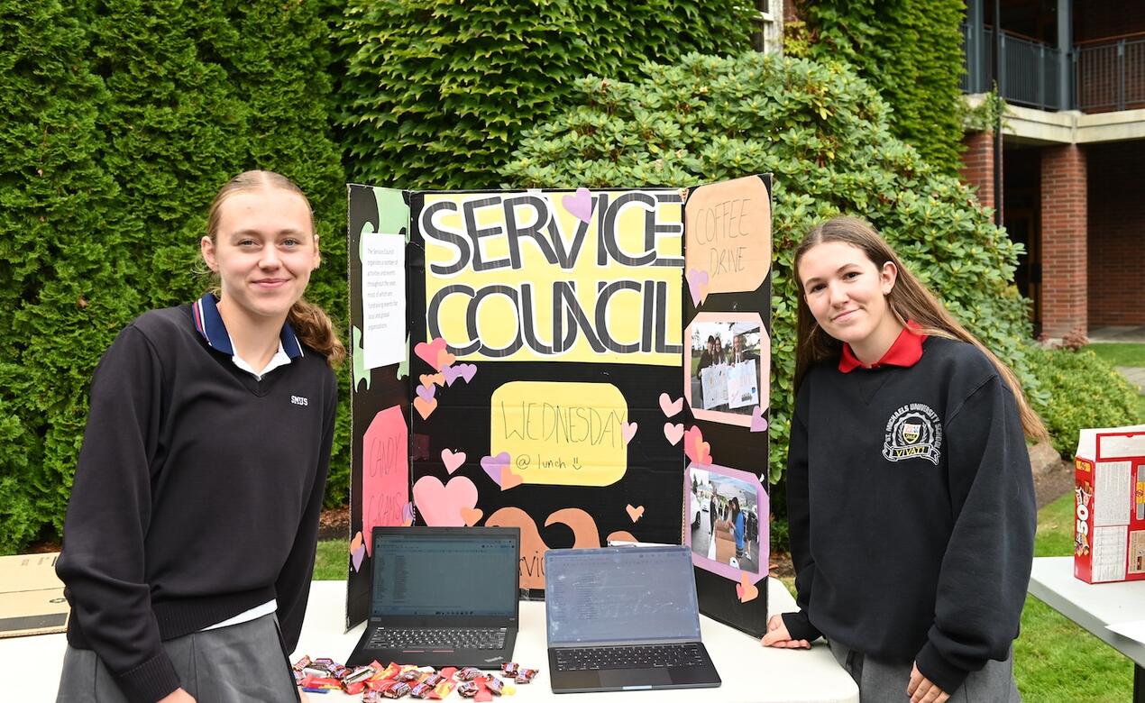 Service Council heads Lucy Turnbull and Bianca Batoni pose with their service council sign and table