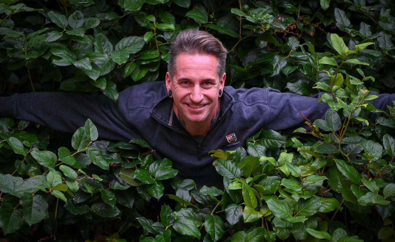 Groundskeeper Colin Craveiro in salal bushes at St. Michaels University School
