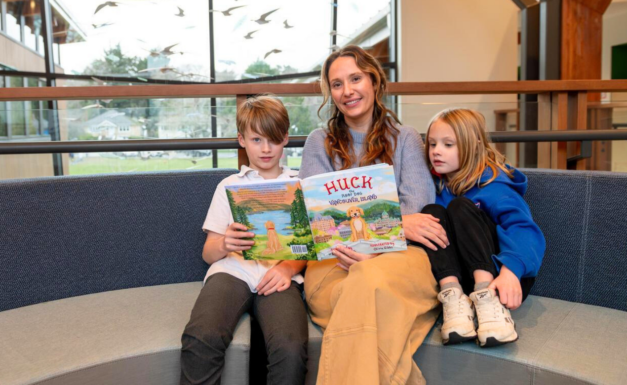 The Lindenmuth family with the book they wrote, Huck the Roof Dog Vancouver Island