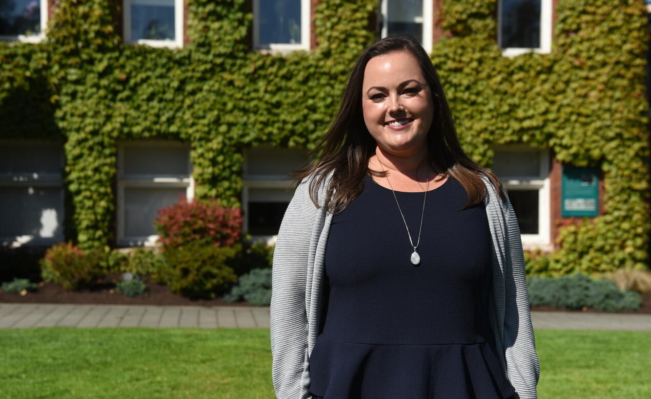 A portrait of Cara Lee in front of School House