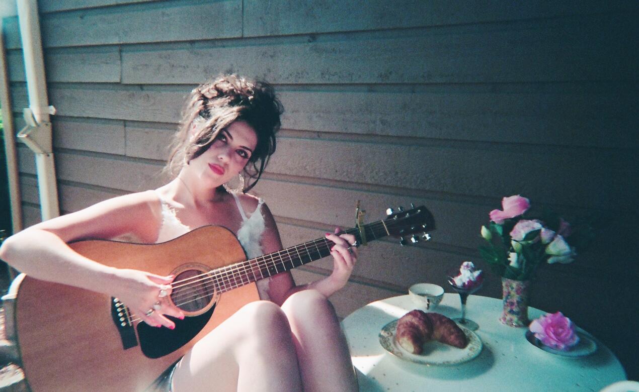 Cati Landry '13 with a guitar