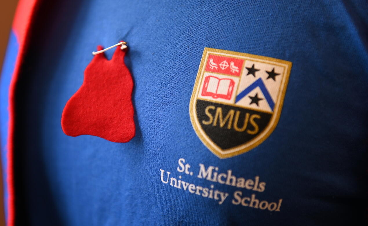 A red dress pin marking MMIW