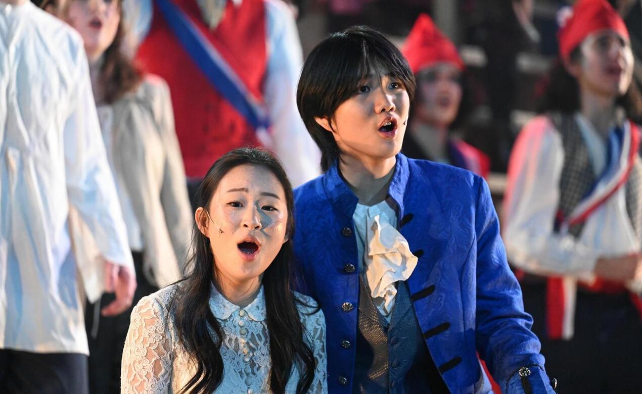 Jared Qin '28 on stage at Les Misérables