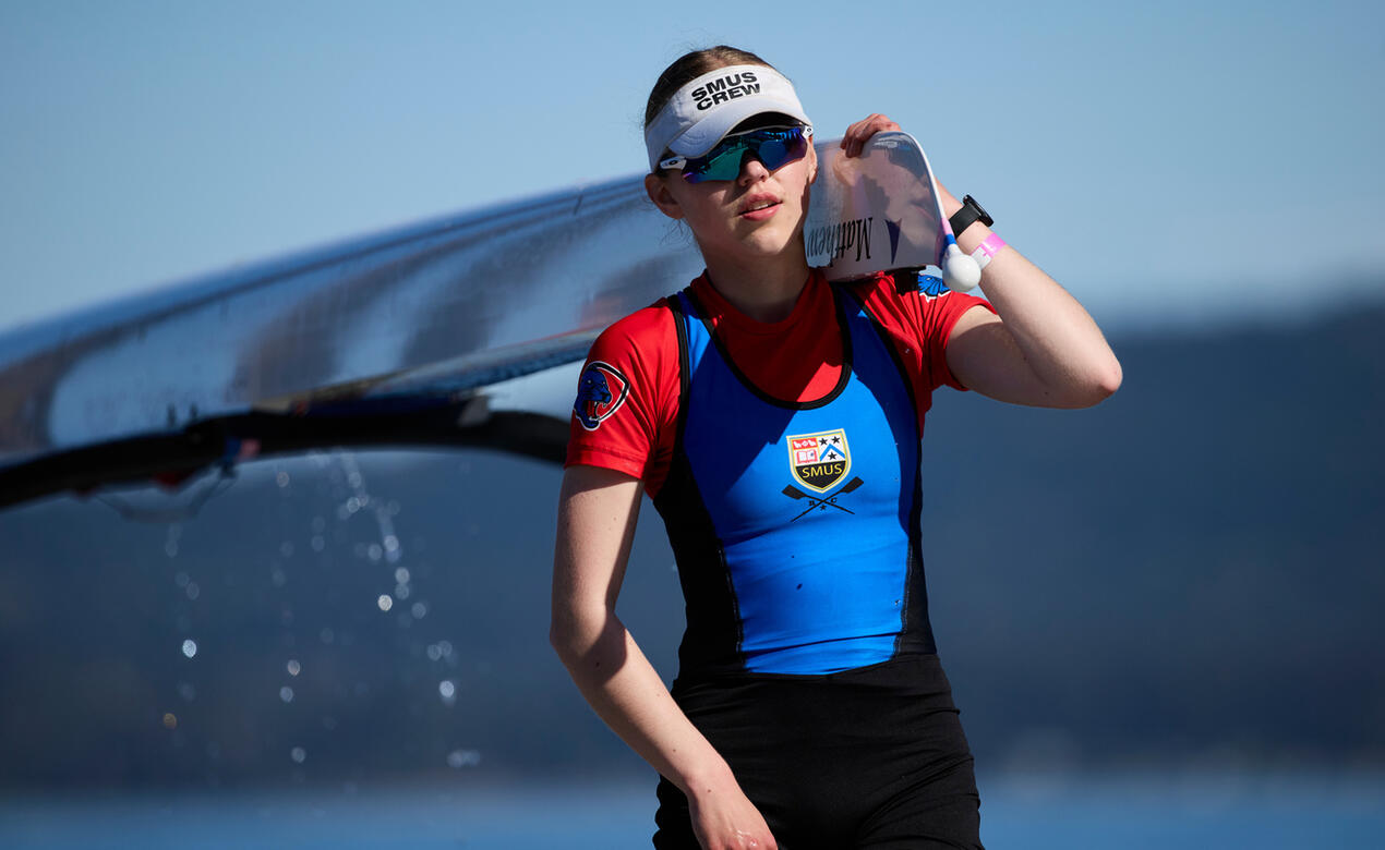 Lucy Turnbull carrying a rowing shell