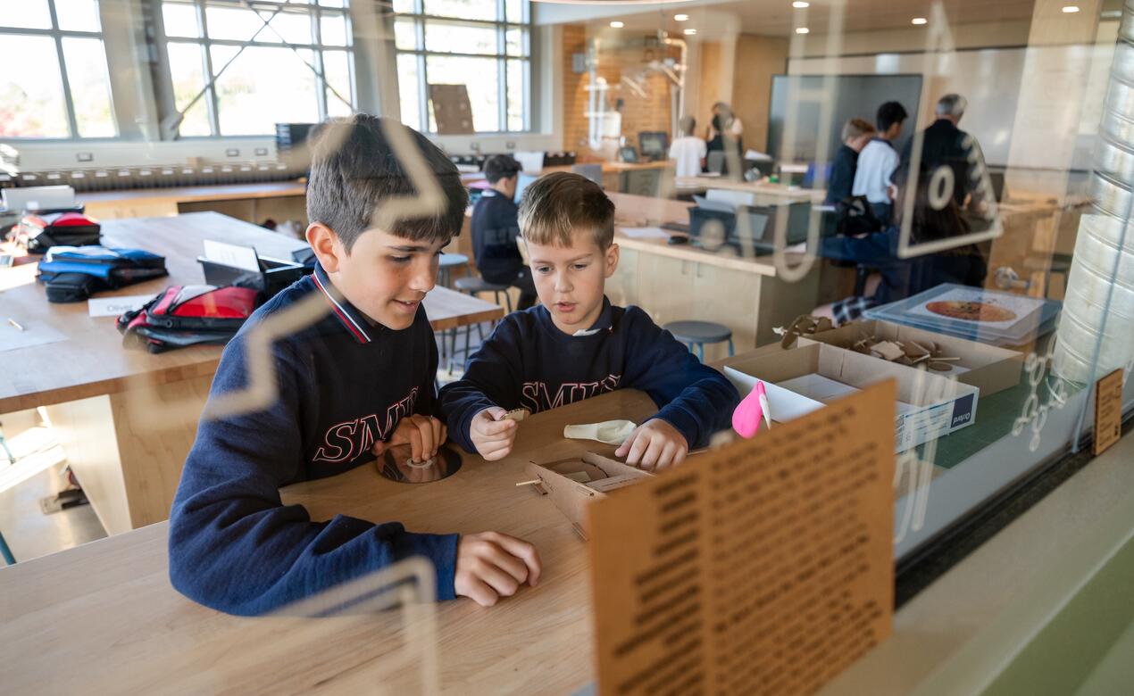 Two students collaborate in the ADST lab of the Considine Annex