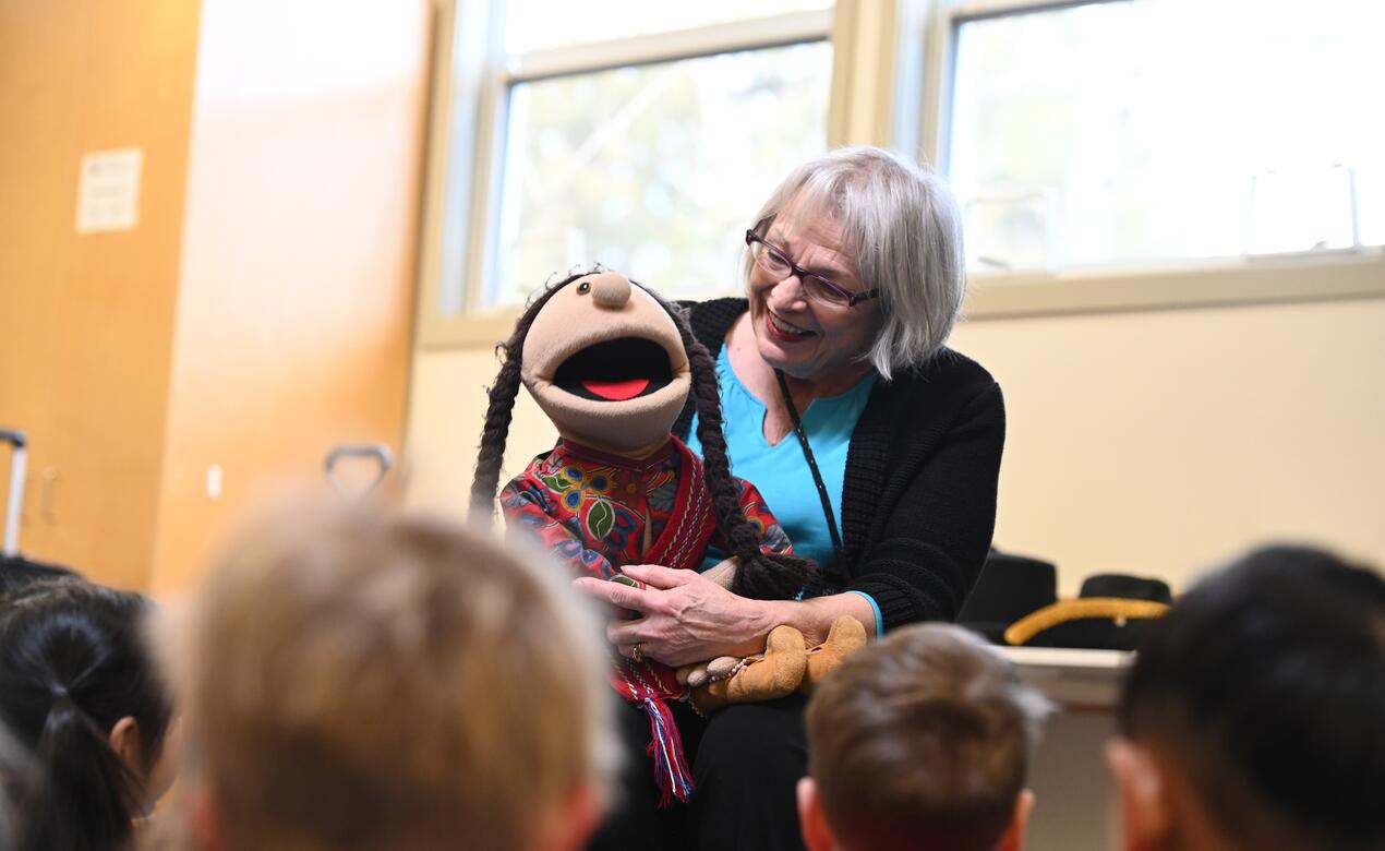 Elder Jo-Ina Young leads a class of Junior School students with her famous Metis puppet