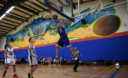 Alumni basketball game with Blue Jag mural in the background