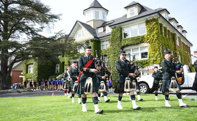 Bagpipers leading a parade of students on Alumni Weekend