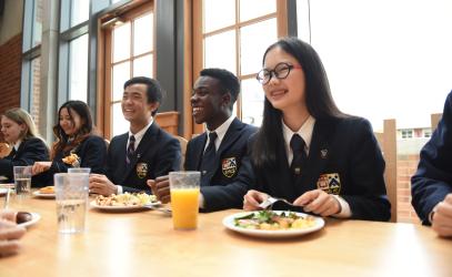 Senior School friends sharing a meal in the dining hall