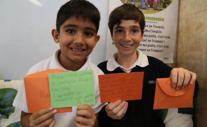 Junior School leadership students showing thank you cards they received