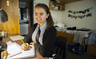 Boarding student studies in their room