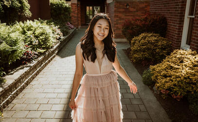 A photo of Chanel Khuu '21 wearing her graduation dress