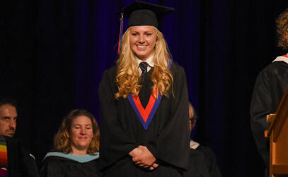 A photo of Shelby Hoogland wearing a cap and gown during the graduation ceremony