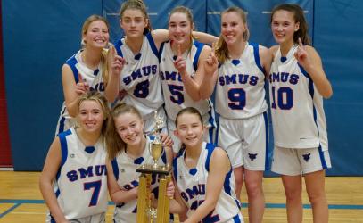The Senior Girls Basketball team poses with the Island trophy.