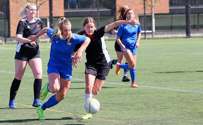 A soccer player competes for possession 