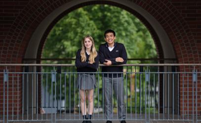 Head Prefects Devon and Jonathan pose for a photo while framed by a brick archway