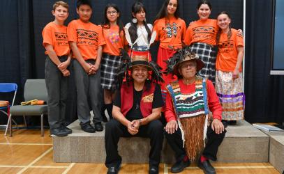 A group of students sit with Wes Edwards and Bill White following a National Day for Truth and Reconciliation ceremony.