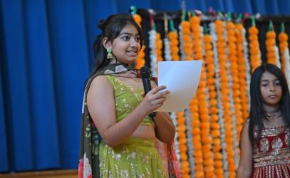 A Junior School student speaks to her schoolmates during the Diwali celebration