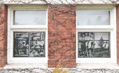 Student-designed art pieces depicting history are displayed in two SMUS windows