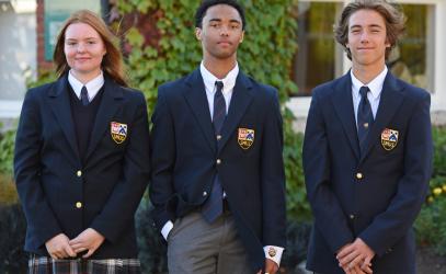 Three students, the 2022-23 Best School Year Ever Winners, pose in uniform.