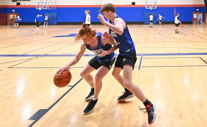 Two Senior School basketball players face off during a practice in the double gym