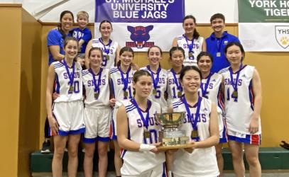 The Junior Girls Basketball team poses with the ISA trophy.