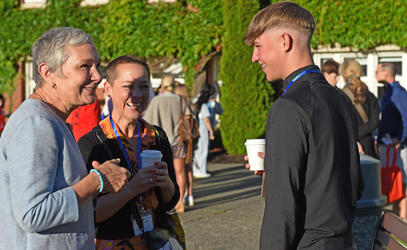 An Admissions representative welcomes a family at Boarding Orientation