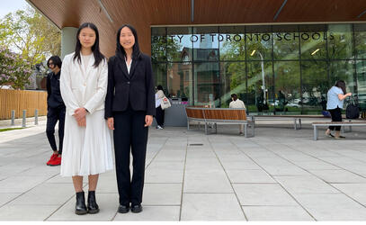 Two debate students stand outside University of Toronto Schools