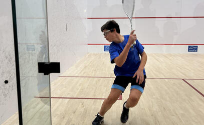 a member of the Blue Jags Squash team backhands the ball at the B.C. Junior Open tournament over the weekend.