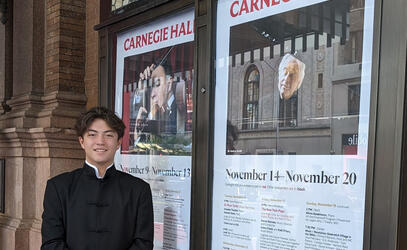 Liam stands outside Carnegie Hall in New York