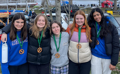 The Women's Coxed Four with their gold medals