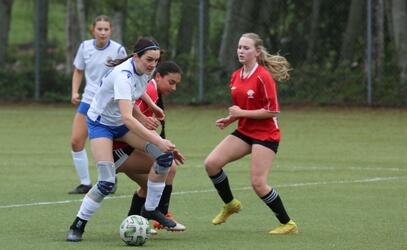 A soccer player defends possession