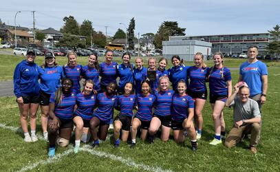 The SMUS Junior Girls rugby team pose for a team photo on the rugby grass field after winning the Esquimalt Sevens tournament. 
