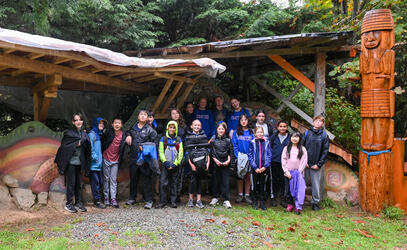SMUS Middle School grade 7 class poses at EcoVillage