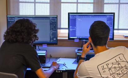 Two Game Development Campers working on their projects in Godot engine