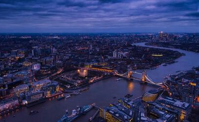 The skyline of London, England at twilight, taken over the Thames.