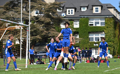 A SMUS student heads the ball away in defence